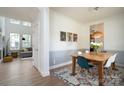 Bright dining room with a wooden table, stylish chairs, and modern light fixture, adjacent to the living room at 12341 Mcallister Park Dr, Charlotte, NC 28277