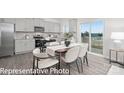 Open kitchen and dining area filled with natural light, stainless appliances, and a view of the outdoors at 1339 37Th Avenue Ne Ln, Hickory, NC 28601