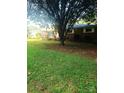Charming one-story brick home with a large tree in the front yard at 1628 Cecelia Dr, Gastonia, NC 28054