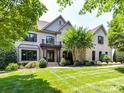 Charming brick home features manicured lawn and inviting curb appeal at 18618 Rollingdale Ln, Davidson, NC 28036