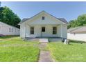 Charming white house featuring a covered porch and neat landscaping at 2414 Lane St, Kannapolis, NC 28083