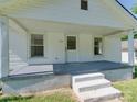 Close-up of a house's inviting covered porch, complete with stairs and white pillars at 2414 Lane St, Kannapolis, NC 28083