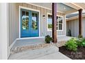 Inviting front porch featuring a stylish blue double door and wood columns at 252 Teeter Rd, Mooresville, NC 28115