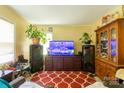 Spacious living room featuring a large flat screen television and patterned red rug at 3037 Marlowe Ave, Charlotte, NC 28208
