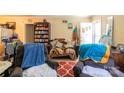 Cozy living room featuring a recliner, blanket covered sofa, and functional layout at 3037 Marlowe Ave, Charlotte, NC 28208