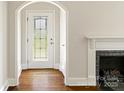 Inviting foyer with decorative glass front door, hardwood floors, and fireplace at 308 Davis Park Rd, Gastonia, NC 28052