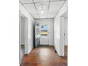 Inviting entryway with hardwood floors, white walls, and a view to the front door and outside at 310 Sidney Johnson St, Fort Mill, SC 29715