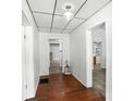 Bright hallway featuring wood-look floors, white wainscoting, and views into adjacent rooms at 310 Sidney Johnson St, Fort Mill, SC 29715