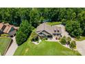 Aerial view showcasing the home's lush landscaping and proximity to the lake and surrounding trees at 313 Sunset View Ct, York, SC 29745