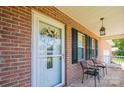 Inviting front porch with seating, brick facade, and decorative wreath on the front door at 4128 River Run Cir, Hickory, NC 28602