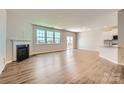 Bright living room featuring hardwood floors, a fireplace, and large windows for ample natural light at 4178 Skyboat Cir, Fort Mill, SC 29715