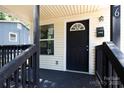 Close-up of a charming front porch with freshly painted black trim and matching door at 426 Williamson St, Rock Hill, SC 29730