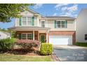 Charming two-story home featuring green shutters, brick accents, and a well-manicured front yard at 4732 Meadowfield Rd # L35, Charlotte, NC 28215
