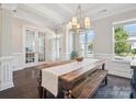 Dining room with a large rustic table, bench seating, and bright natural light at 500 Landau Rd, Waxhaw, NC 28173