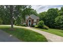 Charming brick home with lush greenery, featuring a curved driveway leading to a welcoming entrance at 61 38Th Nw Ave, Hickory, NC 28601
