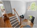 Grand foyer features hardwood floors, a staircase with white railings, and a view of the office at 6800 Augustine Way, Charlotte, NC 28270