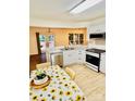 Bright kitchen featuring white cabinets, stainless appliances, and an open layout at 7215 Wingstone Ln, Charlotte, NC 28262
