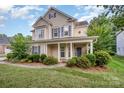 Two-story home featuring a welcoming front porch with classic columns and neat landscaping at 7731 Sedgebrook E Dr, Stanley, NC 28164