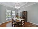 Elegant dining room featuring tray ceilings, wood floors, and large windows at 918 Kite Dr, Fort Mill, SC 29715