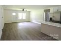 Open-concept living room with modern flooring and ample natural light at 9208 Detroiter Dr, Huntersville, NC 28078