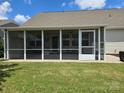 A view of the screened-in porch from the backyard, offering an additional area for relaxation at 1224 Dali Blvd, Mount Holly, NC 28120