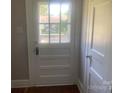 Bright entryway featuring a classic wooden door with glass panel and clean, neutral walls at 1242 Mitchell Ave, Statesville, NC 28677