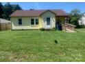 View of a well-maintained single-Gathering home with a lush green lawn and inviting entrance at 1242 Mitchell Ave, Statesville, NC 28677