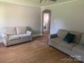 Cozy living room showcasing hardwood floors and two comfortable couches perfect for relaxation at 1242 Mitchell Ave, Statesville, NC 28677