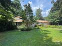 Well-maintained single-story home with lush greenery, garden, and manicured lawn at 126 Aqua Dr, Mooresville, NC 28117