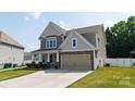 Beautiful two-story home with well-maintained landscaping, a two-car garage, and a concrete driveway at 12704 Franklin Square Rd, Charlotte, NC 28213