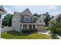 Charming two-story home featuring a welcoming front porch, attached two-car garage, and well-maintained lawn at 12704 Franklin Square Rd, Charlotte, NC 28213