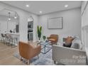 Bright living room featuring modern decor, stylish furniture, and an open layout with a view to the kitchen at 13115 Meadowmere Rd, Huntersville, NC 28078