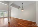 Bright living room featuring hardwood floors, pillars, and modern lighting at 1326 Anthem Ct, Charlotte, NC 28205