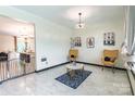Bright open living room with modern white tile, chairs, and neutral walls at 154 Tanner Loop, Troutman, NC 28166