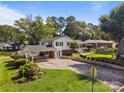 View of a two-story home with a covered parking area and well-maintained landscaping at 1632 Kimberly Dr, Gastonia, NC 28052