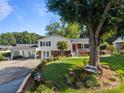 Inviting home exterior showcasing mature trees, landscaped garden beds, and a cozy bench at 1632 Kimberly Dr, Gastonia, NC 28052