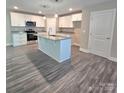 Bright kitchen boasts white cabinets, granite countertops, stainless steel appliances, and an island at 206 N Kayla Dr, Salisbury, NC 28146