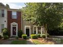 Charming townhome with black front door, bay window, and manicured landscape at 2273 Aston Mill Pl, Charlotte, NC 28273