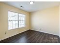 Bright bedroom with a large window allowing ample natural light and wood laminate flooring at 2357 Riding Trail Rd, Gastonia, NC 28054