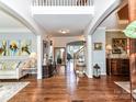 Spacious foyer with gleaming hardwood floors and elegant decor welcomes guests with style at 27246 Preston Pl, Fort Mill, SC 29707