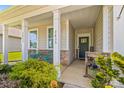 Inviting front porch with decorative columns and front door at 3835 Norman View Dr, Sherrills Ford, NC 28673