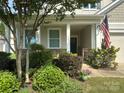 Inviting front porch with decorative plants and an American flag at 3835 Norman View Dr, Sherrills Ford, NC 28673