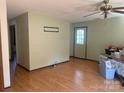 Bright living room with hardwood floors, a ceiling fan, and a back door to the backyard at 3973 English Oak Dr, Lincolnton, NC 28092
