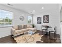 Charming living room features ample natural light, modern decor, and hardwood flooring at 404 Wakefield Dr # C, Charlotte, NC 28209