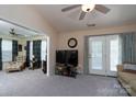 Open concept living room with doors to the outside, plenty of light, and neutral colors at 407 Hertling Nw Dr, Concord, NC 28027