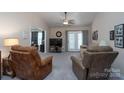 Spacious living room with plush carpet, comfortable seating, and convenient access to other areas at 407 Hertling Nw Dr, Concord, NC 28027