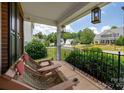 Relaxing front porch featuring comfortable chairs and scenic neighborhood views at 512 Veloce Trl, Fort Mill, SC 29715