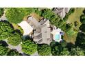 An aerial view shows a gorgeous home with a pool, and a beautiful, lush green landscape surrounding it at 600 Beauhaven Ln, Waxhaw, NC 28173