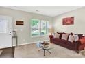 Cozy living room featuring a large window offering plenty of natural light and neutral wall paint at 7339 Dover Mill Sw Dr, Concord, NC 28025