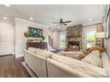 Cozy living room featuring a stone fireplace, neutral-toned furniture, and ample natural light at 7805 Crooked Creek Church Rd, Monroe, NC 28110